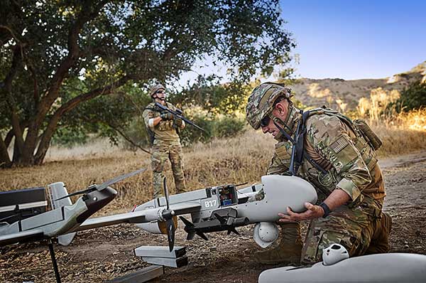 Soldiers preparing the P550 autonomous Group 2 eVTOL UAS for launch